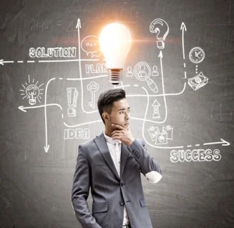 front-view-asian-businessman-thinking-looking-right-blackboard-with-solution-sketch-it-bright-light-bulb-is-his-head (2)